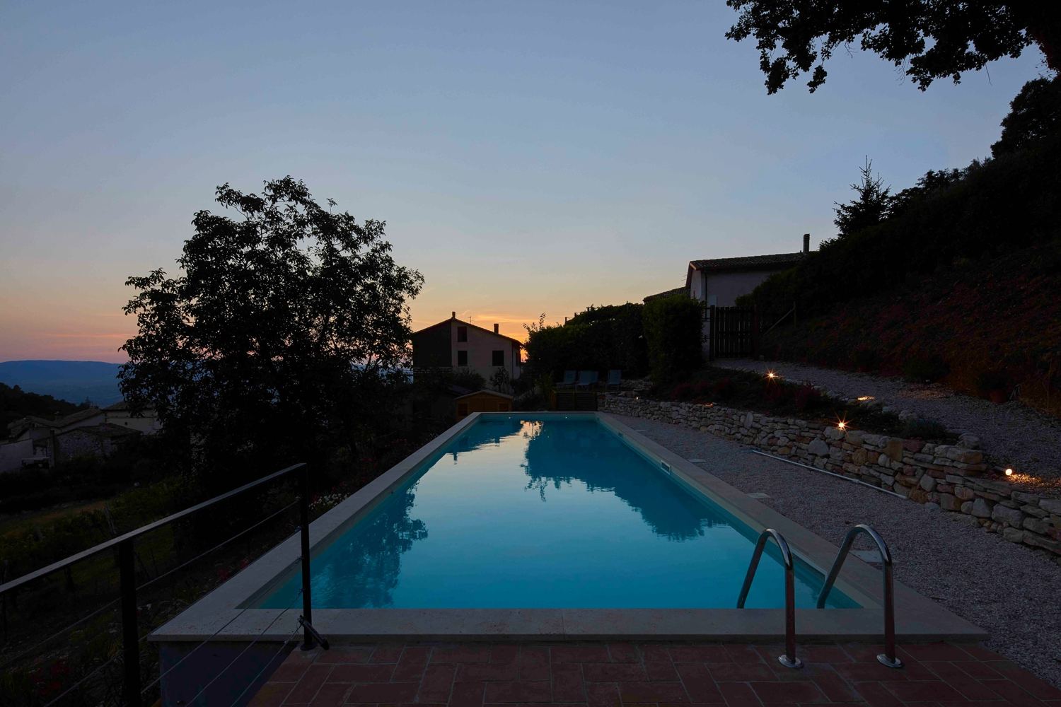 The pool at dusk reflecting the sunset